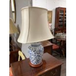 A pair of modern ceramic blue and white ginger jar form lamps with cream shades, 67cm tall,