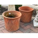 A pair of terracotta jardiniere/pots with diamond lattice detail