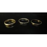 Two 22ct gold bands, sizes O and P, 5.4g and an eternity ring, unmarked. Size R, 1.5g