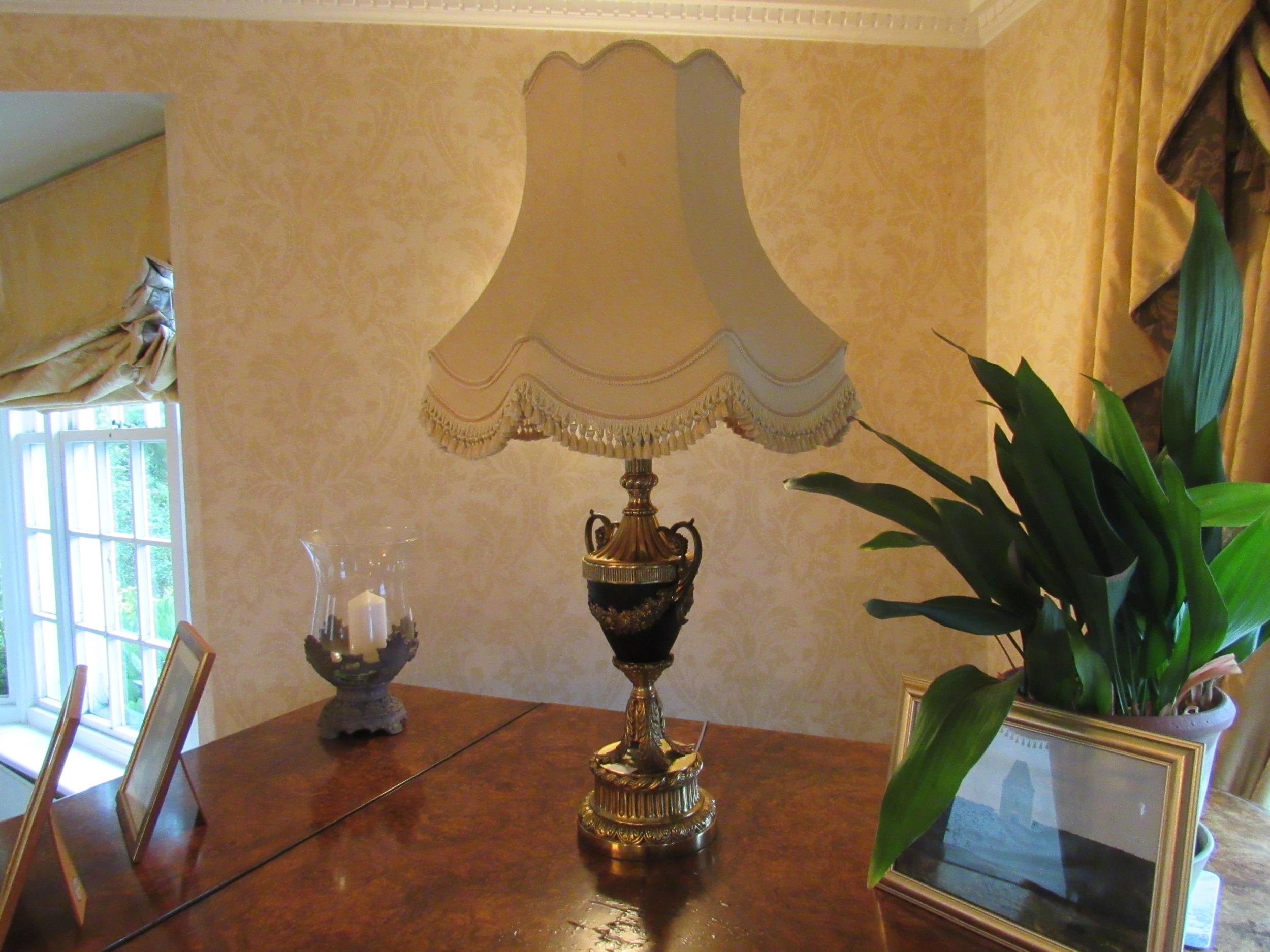 A Classical French style table lamp of urn form with swag and leaf detail, tasselled shade,