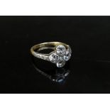 A gold ring with four 0.20ct approx diamonds in floral shape, small diamond to centre and diamond