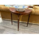 A Georgian style mahogany demi-lune side table with reeded legs, 76cm long