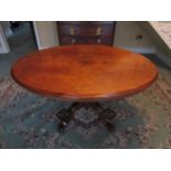 A Victorian walnut centre table with central diamond form lozenge, turned stem to quatraform base.