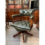 A modern leather button-back office swivel captains chair