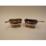 A pair of George III silver mustards, London 1819 markers mark W.E, 9cm long, with associated spoons