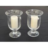 Two glass candle lamps on pedestal bases