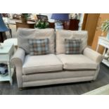 A modern beige two seater sofa with feather filled cushion, fire labels to cushions approx 167 long
