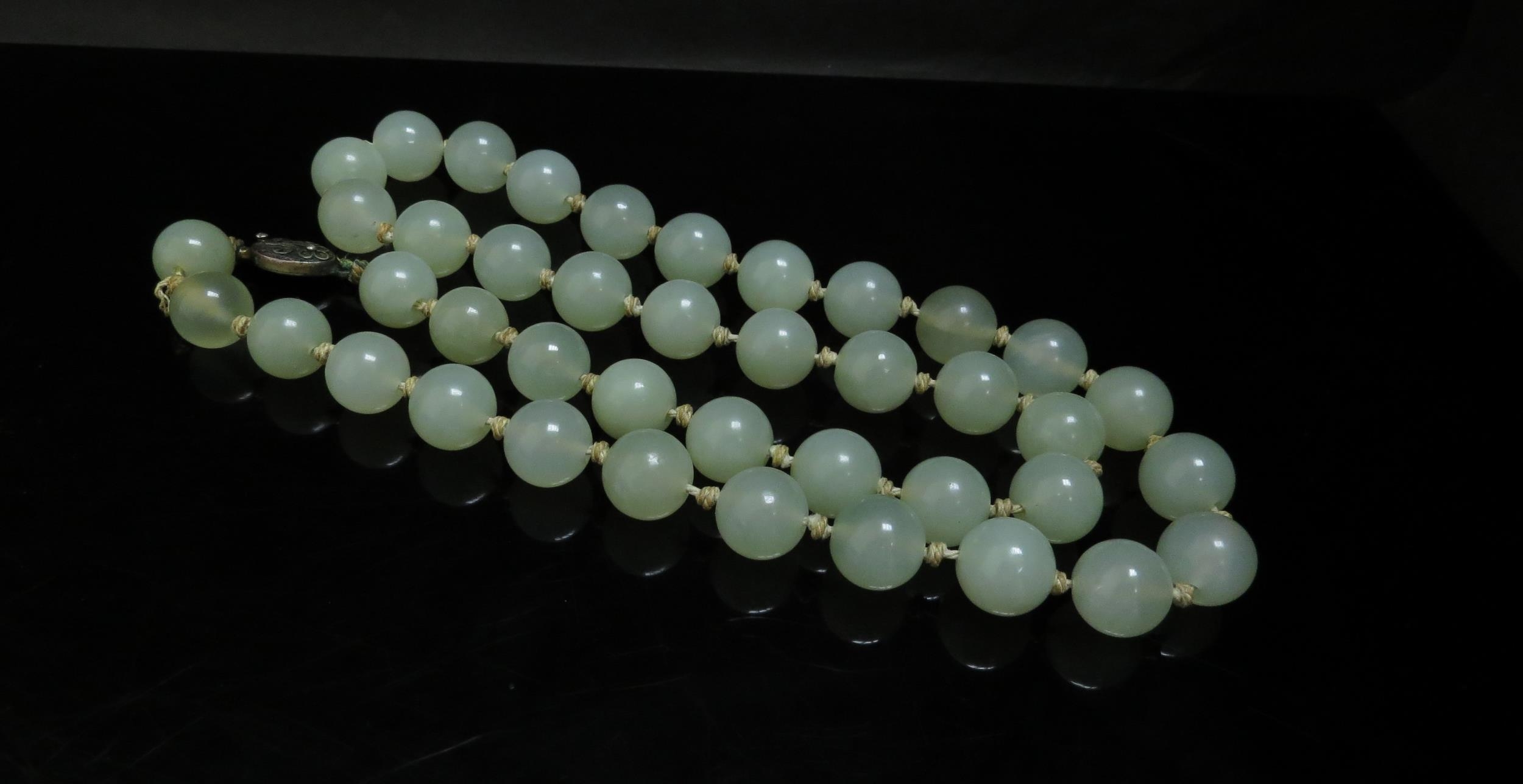 A Jade necklace with silver clasp, 14mm beads, 65cm long, 138g