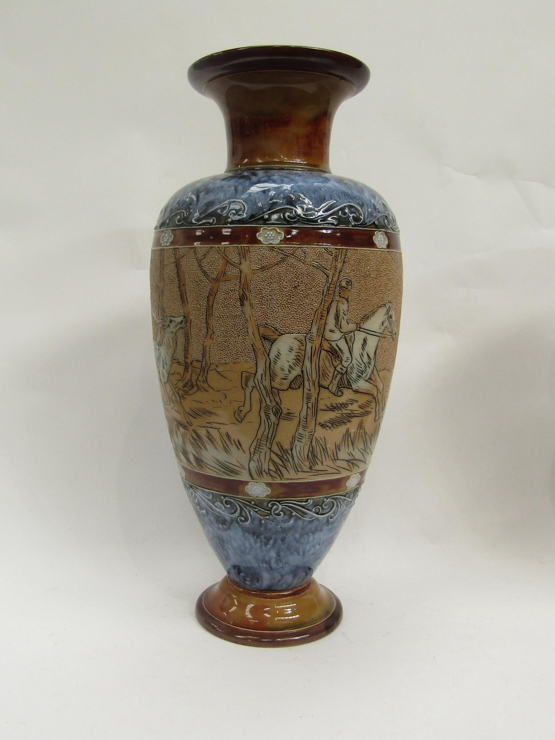 A Royal Doulton Hannah Barlow vase decorated in scraffito with stag hunting scene. Firing crack to
