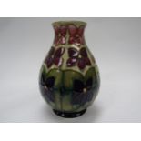 A Moorcroft Violet pattern vase, 19cm tall