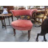 A 19th Century library tub chair with carved scroll splat, deep pink velour upholstery, turned