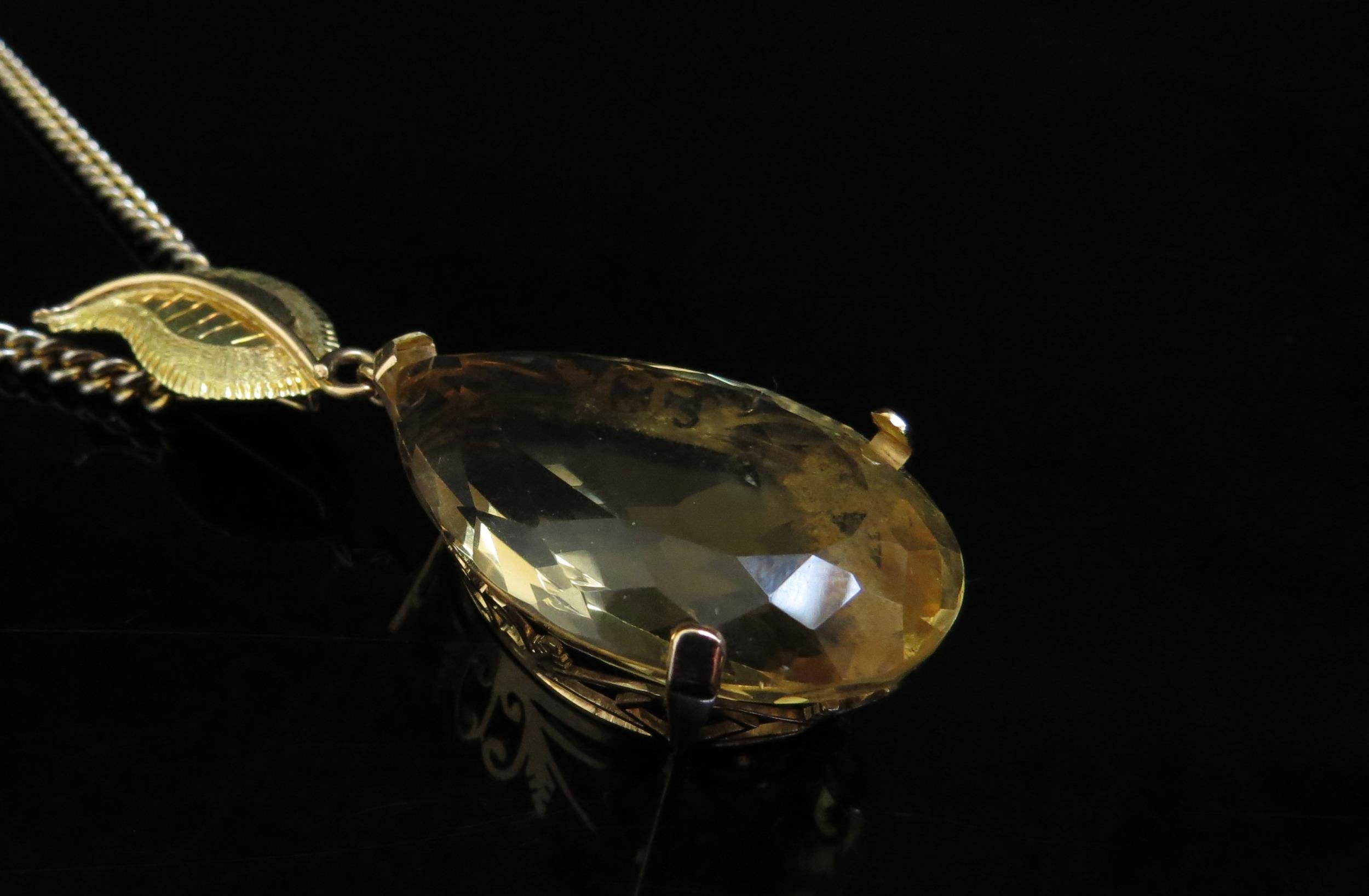 A large pear shaped citrine pendant, 4cm long in 14ct gold mount with later applied 18ct gold leaf - Image 2 of 4