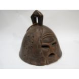 An Ethnic African handcrafted helmet mask with bearded gentleman detail with eye, mouth and sound