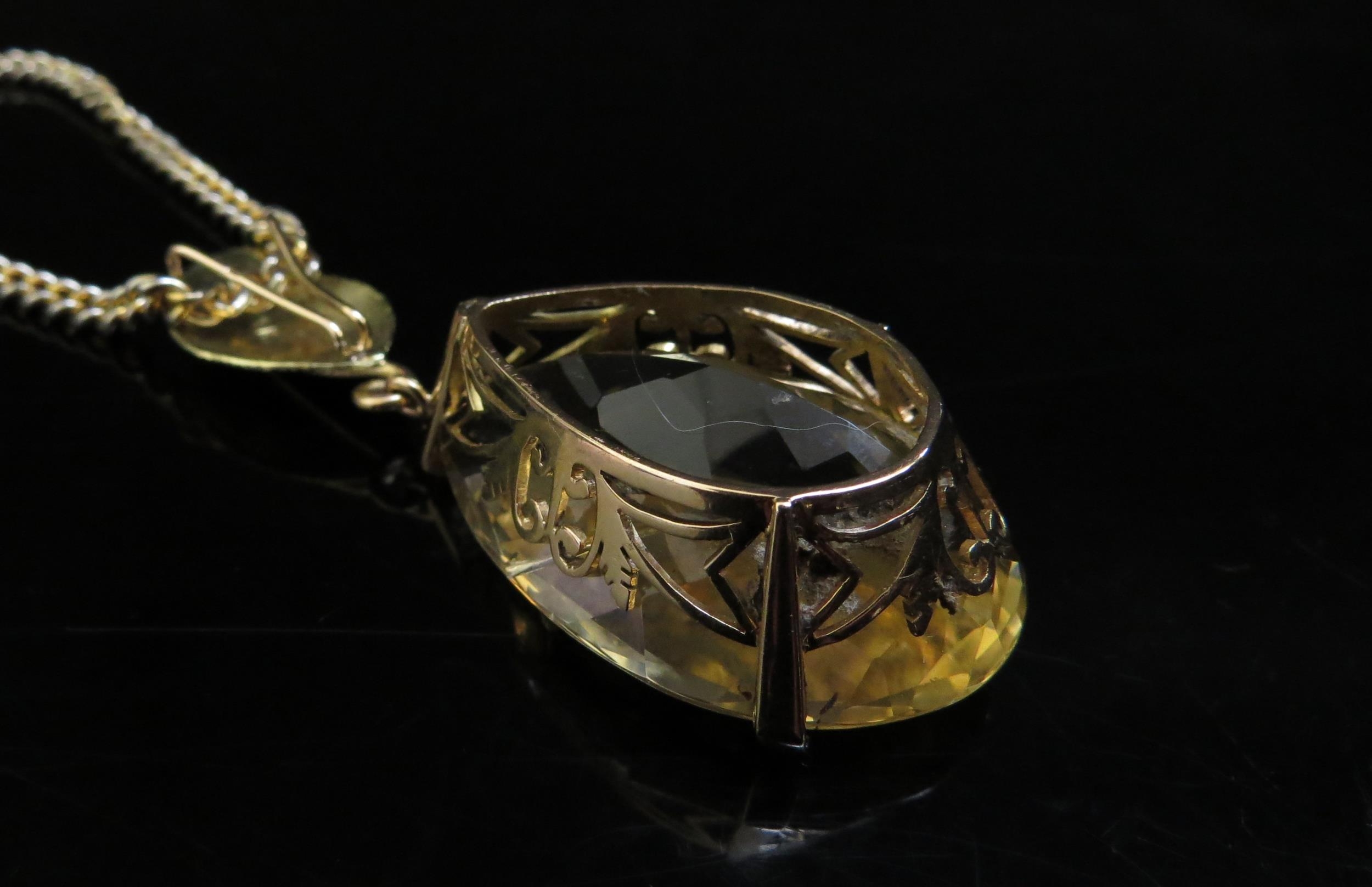 A large pear shaped citrine pendant, 4cm long in 14ct gold mount with later applied 18ct gold leaf - Image 3 of 4