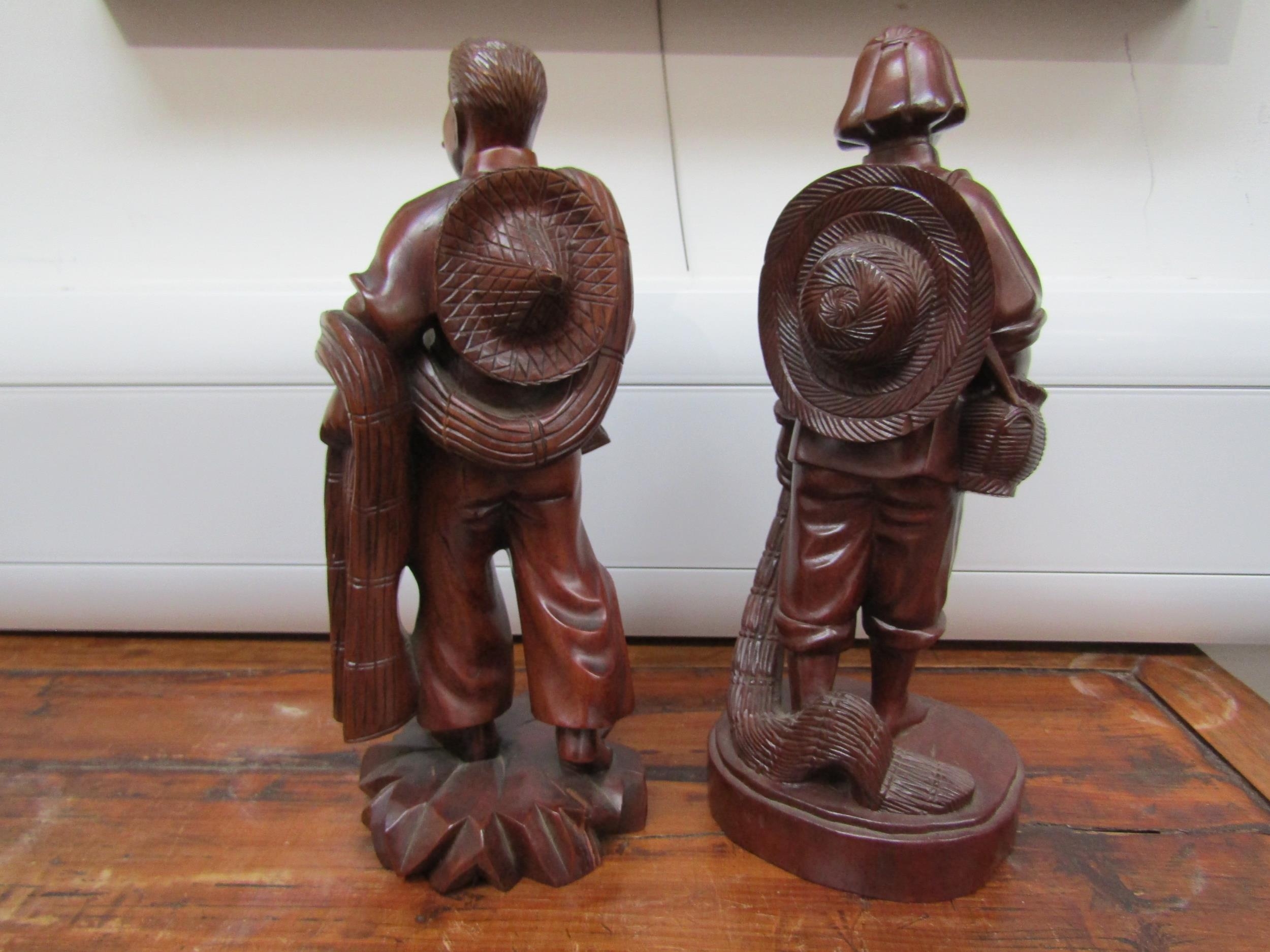 Eastern carved wood figures, 27cm tall - Image 2 of 3