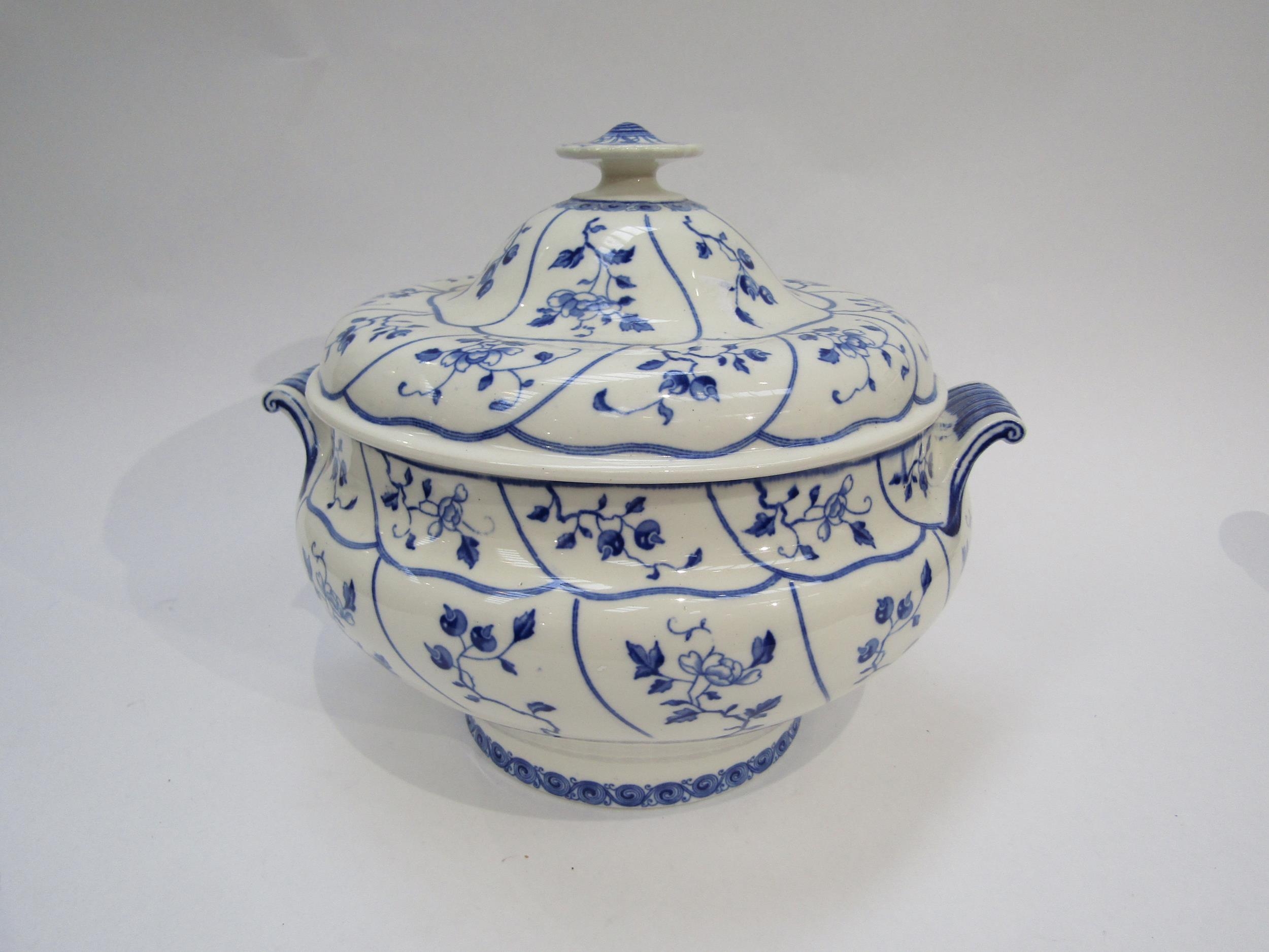 A 19th Century Minton blue and white soup tureen with scrolling handles, branch and leaf sprawling