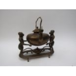 An Edwardian brass Indian Colonial spirit kettle with standing monkey support, engraved