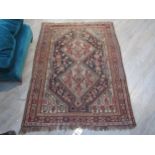 A Persian hand-knotted rug with central lozenge field, 150 cm x 110cm