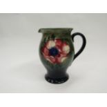 A Moorcroft Anemone pattern jug on green to blue ground, 19cm tall