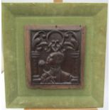 A 17th Century or earlier carved oak panel, mounted on green velour frame 23cm x 21cm