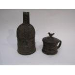 A Peruvian metal temple bell and lidded cup, surmounted by bird, 22cm tall & 12.5cm tall, holes to