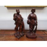 Eastern carved wood figures, 27cm tall