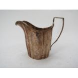 A Victorian Thomas Hughes Headland silver milk jug with melon fluted sides, lion crest detail,