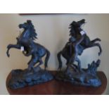 A pair of spelter cast Marley horses, feet damaged, 40cm tall, 30cm long