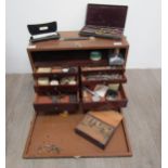 A watch repairers travelling cabinet with horological tools and parts