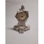 A 20th Century Dresden timepiece with applied and painted floral decoration, 20cm tall