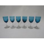 A set of six Victorian blue wine/sherry glasses, the bowls with wrythen lower halves, clear stems