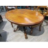 A Victorian walnut centre table with central diamond form lozenge, turned stem to quatraform base.