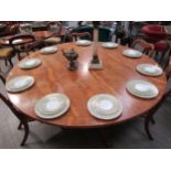 A Regency style yew wood circular dining table of large proportions. The top 182cm diameter on a