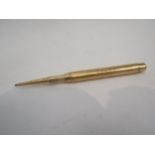 A gold propelling pencil, marks worn, inscribed Peter