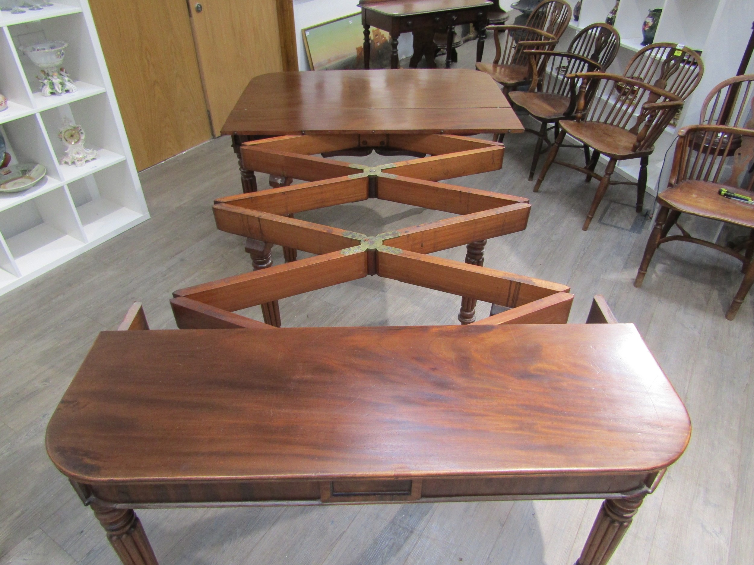 A Georgian mahogany concertina action extending dining table of rounded square form raised upon - Image 6 of 7