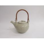 A pale celadon glazed studio pottery teapot with cane handle. Impressed seal to base for Glen Barron