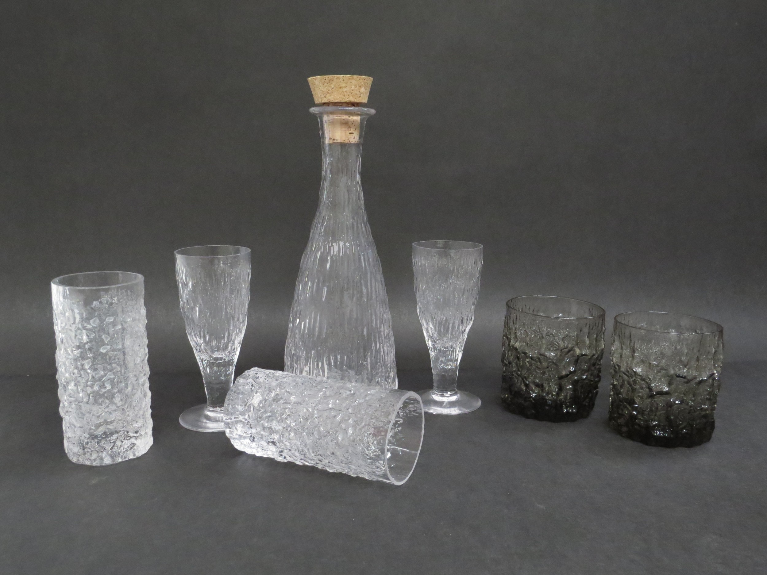 A collection of Whitefriars drinking glasses and decanter in Icicle and bark textures in clear and