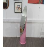 An elongated eliptical "lipstick" mirror on a column stand, painted pink, 157.5cm high
