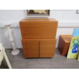 A Beaver & Tapley teak "33" wall cabinet with fall front door, 83.5cm x 40.5cm x 40.5cm and a