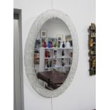 An oval mirror lucite frame manner of German Hillebrand, 60's/70's. 71cm x 48cm