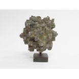 A metal abstract sculpture of geometric form intialled MC and dated 1966. 12cm high