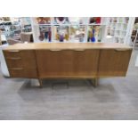 A Mcintosh Furniture sideboard with three cupboard doors and three drawers. 201.5cm x 49cm x 77cm