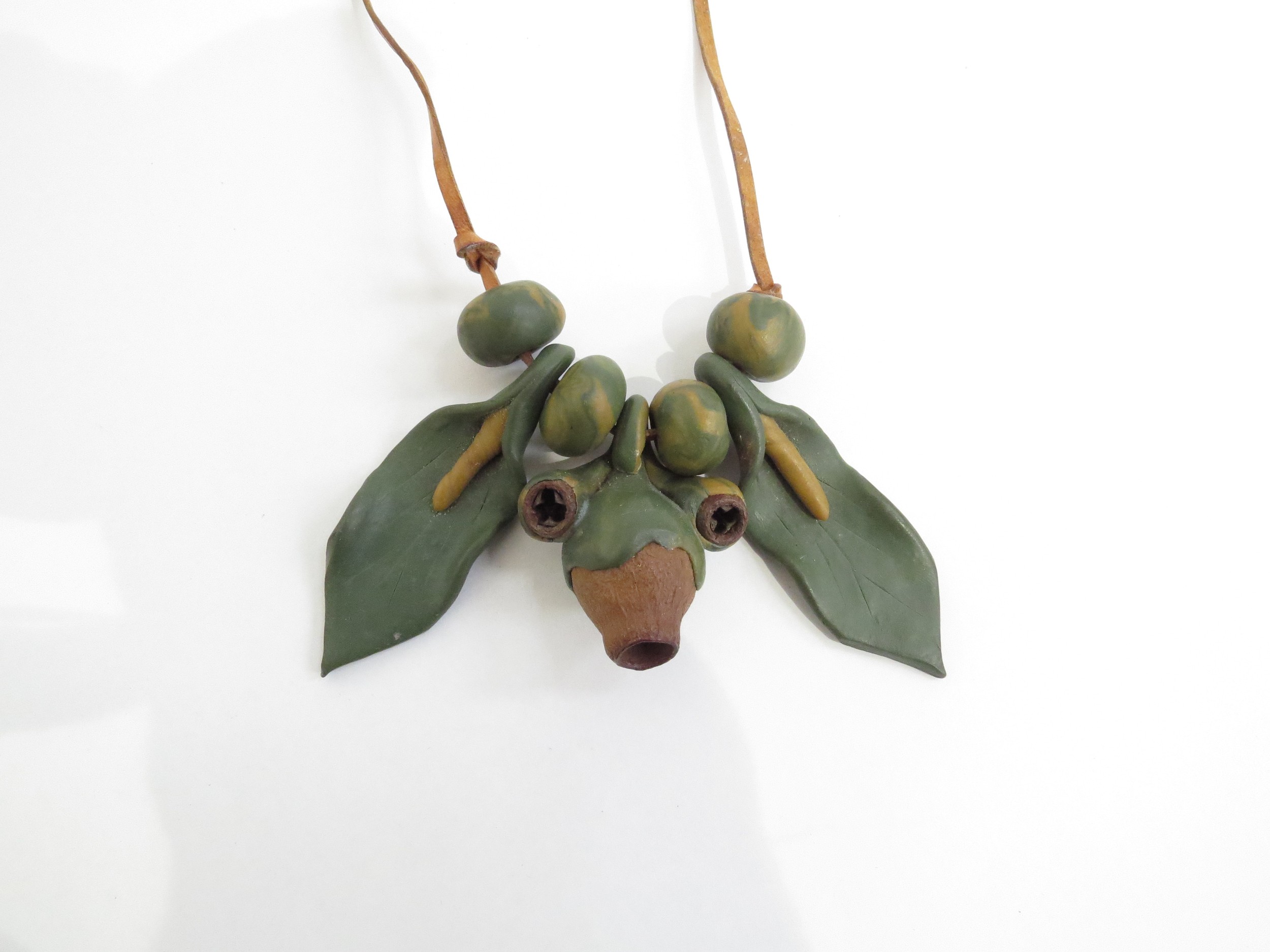 A 1970's seed pod and clay organic necklace on leather thong.