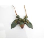 A 1970's seed pod and clay organic necklace on leather thong.