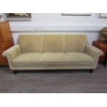 A 1940's Danish three seater sofa with original pale gold embossed upholstery, raised on dark
