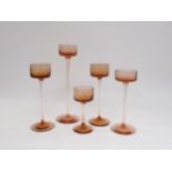 A collection of five Wedgwood Glass Brancaster candle holders by Ronald Stennett-Willson in topaz