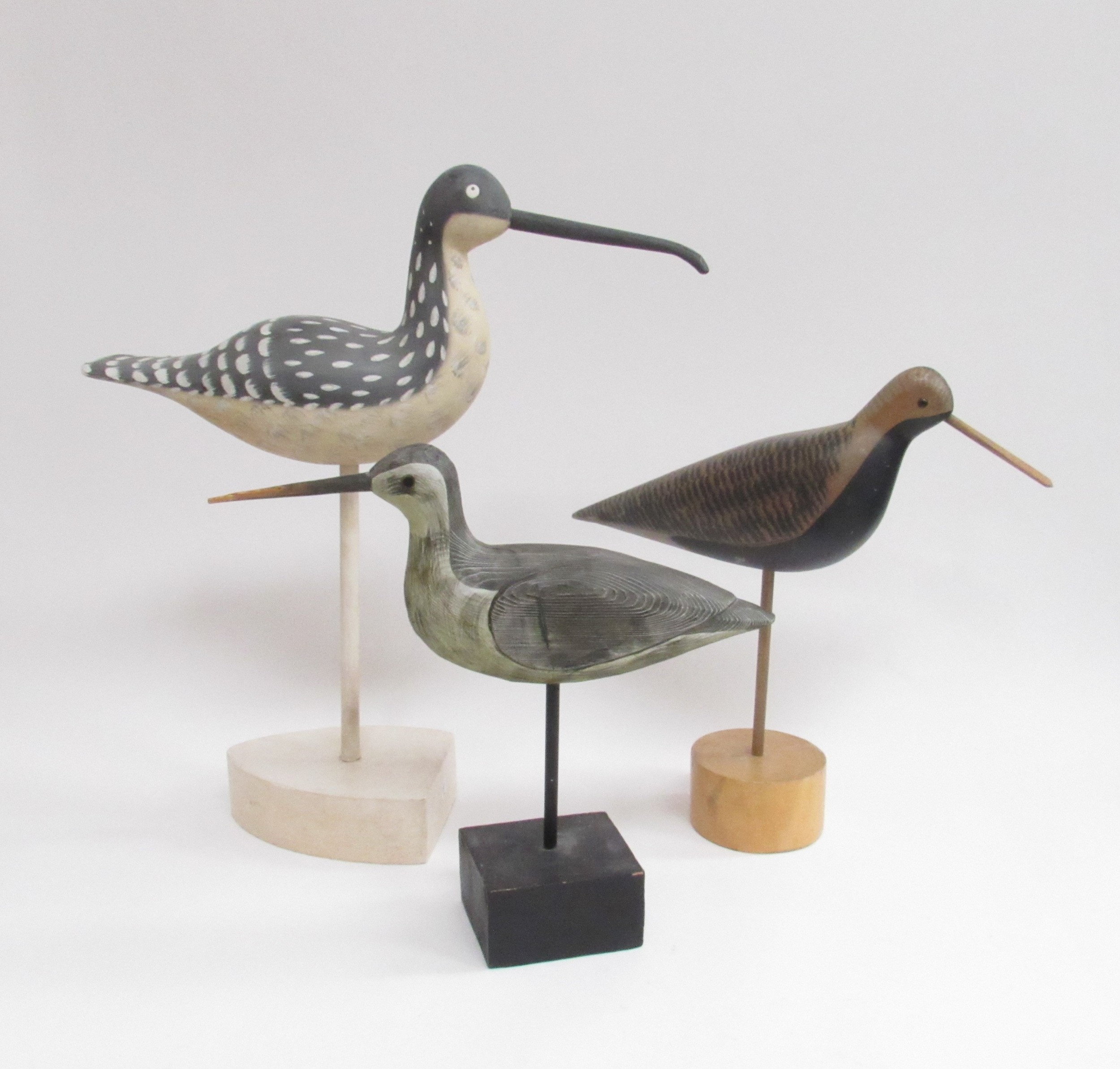 Three carved hand painted wooden bird sculptures in the style of Guy Taplin. Tallest 43cm