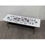 A 1960's low coffee table, metal frame with formica top with floral design after John Piper for