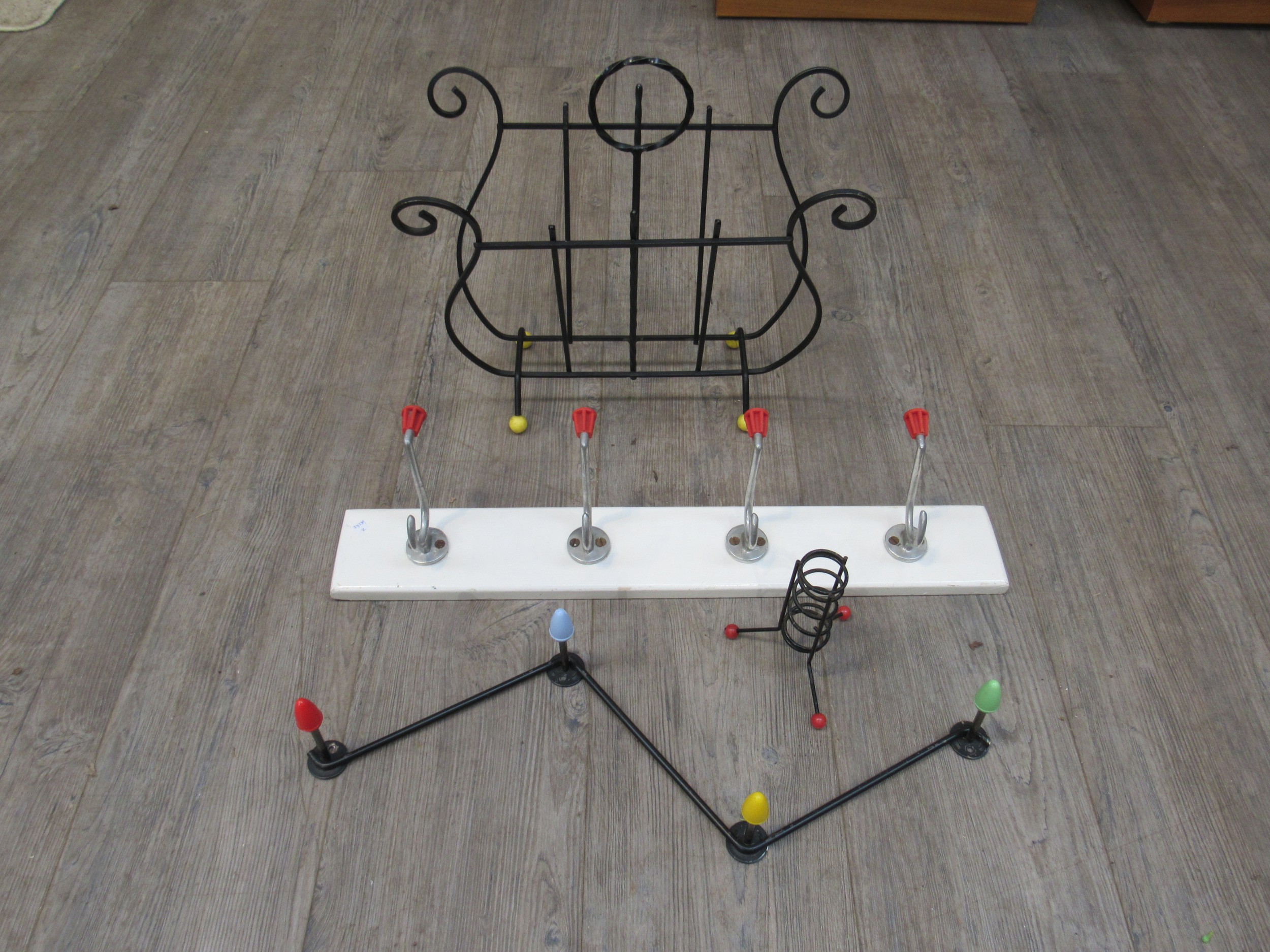 An Atomic/Sputnik style 1950's candle holder, magazine rack and two 1960's wall mounting coat racks.