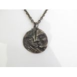 A 1960's pewter pendant necklace featuring male and female heads.